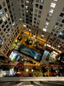 an overhead view of a large building with a pool at Golden Apartment in Ho Chi Minh City