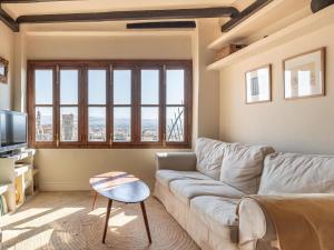 a living room with a couch and a tv at Carmen de Azahar in Granada