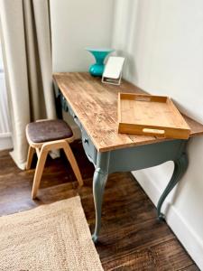 a desk in a room with a chair and a table at Cooden Cottage in Bexhill