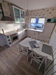 a small kitchen with a table and chairs in it at Ferienhaus To Huus in Langen