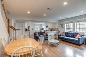 sala de estar con sofá azul y mesa en Long Branch Getaway - Walk to Beaches and Dining!, en Long Branch