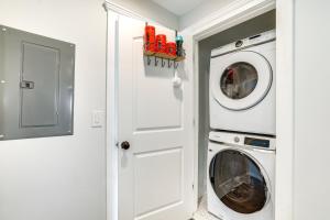 a white laundry room with a washer and dryer at Long Branch Getaway - Walk to Beaches and Dining! in Long Branch