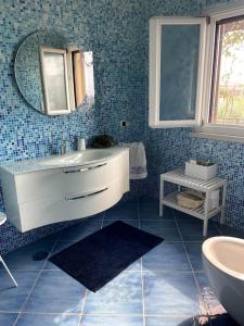 a bathroom with a sink and a mirror at Luxury villa al mare in Calabria Diamante in Cirella