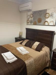 a bedroom with a large bed with towels on it at Cantinho da Estrela in Seia
