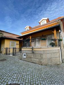 une maison avec balcon dans une rue en briques dans l'établissement Cantinho da Estrela, à Seia