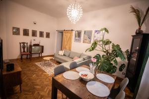 a living room with a couch and a table at Apartament Miedziana City Center in Warsaw