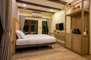 1 dormitorio con 1 cama y TV en Miranda's House Khaokho มิรันดาเฮ้าส์ เขาค้อ, en Ban Lao Kok Kho