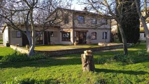 a house with a tree stump in front of it at CASALE SUL CLITUNNO in Foligno