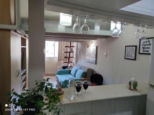 a kitchen and living room with two wine glasses on a counter at Ipanema Flat in Rio de Janeiro