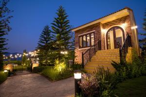 a brick house with stairs and lights on it at Miranda's House Khaokho มิรันดาเฮ้าส์ เขาค้อ in Ban Lao Kok Kho