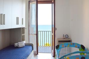 a bedroom with a bed and a view of the ocean at STELLA MARINA VACATION in Pozzallo