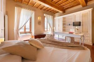 una camera con letto bianco e scrivania di Keys of Italy - Ghibellina 80 Big - Trilo comodo e ampio a Firenze
