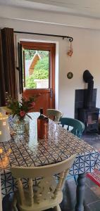 a table in a room with a fireplace and a window at Vale View Cottages -The Coach House in Prestatyn