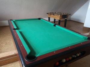 a snooker table with a chessboard in a room at Ferienzimmer Schneider in Herbstein