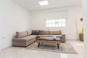 a living room with a couch and a coffee table at Faliro 2 Bd Escape Modern Living Redefined in Athens