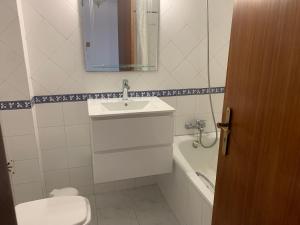 a bathroom with a sink and a toilet and a tub at Sesimbra Concept in Sesimbra +20 photos