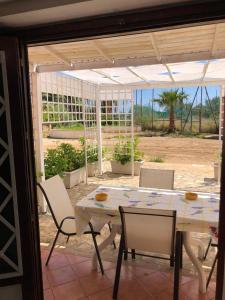 a patio with a table and chairs on a patio at Milicia Apartment in Mandra Capreria