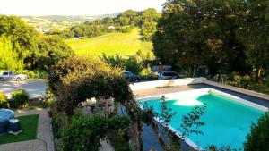 a swimming pool in a yard with a parking lot at Degli Alessandri house in Sassoferrato