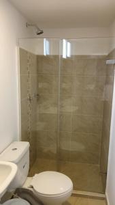 a bathroom with a shower with a toilet and a sink at Apartamento Turístico Santa Marta punta gaira in Santa Marta +3 photos