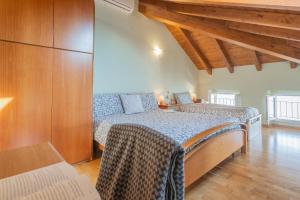 ラーリオにあるGiuliano's House - Amazing Lake View by Rent All Comoのベッドルーム1室(ベッド2台付)