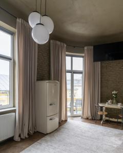a kitchen with a white refrigerator and a table at Apart hotel на Франка by Willox in Chernivtsi