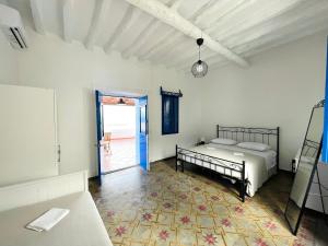 1 dormitorio con 1 cama y puerta que da a un patio en Villa Margherita - Appartamenti a due passi dal corso di Santa Marina Salina a 100 mt dalla spiaggia, en Santa Marina Salina