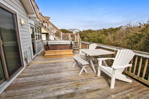 a wooden deck with a table and chairs on it at Oceanside, Hot Tub, Rec Room, OD1, The Sandy Dune in Duck