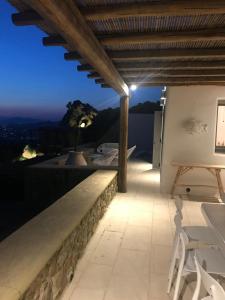 a balcony with a view of the city at night at Luxury Sunset in Mýkonos City