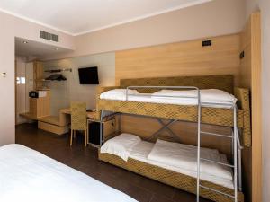 a room with two bunk beds and a desk at Hotel Resort Villa Luisa & Spa in San Felice del Benaco