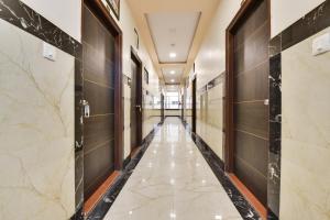 a corridor of a building with marble floors and walls at Super OYO Flagship Hotel Ratnam Palace in Udaipur