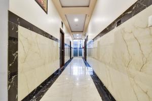 a corridor of a building with marble walls at Super OYO Flagship Hotel Ratnam Palace in Udaipur