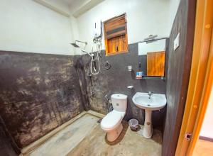 a bathroom with a toilet and a sink at Inside Out Nature Villa in Kandy