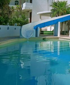 un tobogán de agua azul en una piscina en tropical en Playa del Carmen