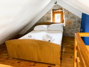 a bedroom with a bed in the attic at Apartman Robi in Vrsine