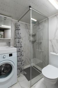 a bathroom with a washing machine and a toilet at Apart hotel на Франка by Willox in Chernivtsi +51 photos