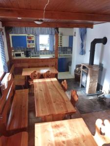 a room with wooden tables and a wood stove at Holiday home in Haj pod Klinovcem 1681 in Háj