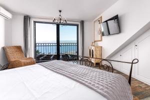 a bedroom with a bed and a large window at Holiday home in Vrbnik - Insel Krk 45251 in Vrbnik +33 photos