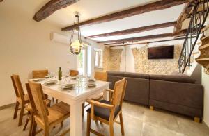 ヴルブニクにあるHoliday home in Vrbnik - Insel Krk 45249のテーブルとソファのあるダイニングルーム