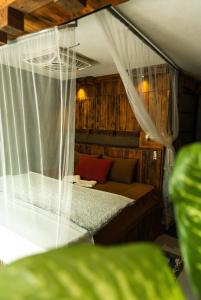 a bedroom with a bed with a mosquito net at La pinchi " Pinchi's Bed " in Gampola