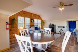 a dining room and living room with a table and chairs at Mountain Jewel Cozy Sevierville Studio with Views in Sevierville