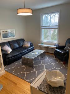 a living room with a couch and a table at North of Avon B&B Suites in Stratford