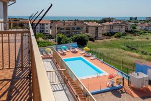 a balcony with a swimming pool and some buildings at Camping Villaggio Il Frutteto in Cupra Marittima
