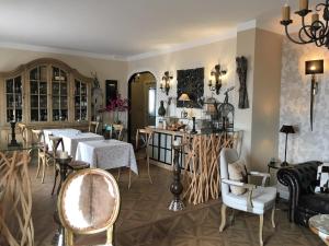 a dining room with two tables and chairs at Villa Liguardi in Proaño