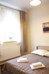 Een bed of bedden in een kamer bij Apartament Integro