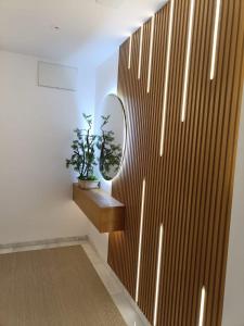 a hallway with a wooden wall with a mirror at APARTAMENTOS SAN NICOLAS in Adra