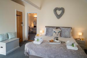 a bedroom with a bed with a tray of food on it at The Granary at Red House Farm in Stradbroke