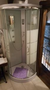 a shower with a glass door in a bathroom at Chalet in pietra in Antey-Saint-André