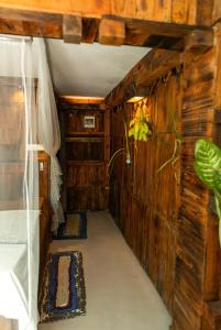 a hallway in a room with wooden walls at La pinchi " Pinchi's Bed " in Gampola