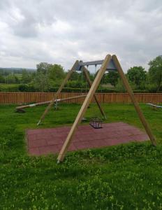 a wooden swing set in a field of grass at Wallfahrtswirt in Wemding