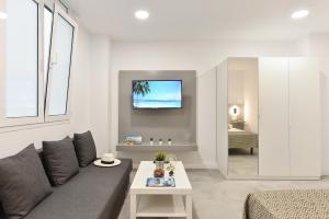 a living room with a couch and a table at Apartamentos Don Carlos in Las Palmas de Gran Canaria